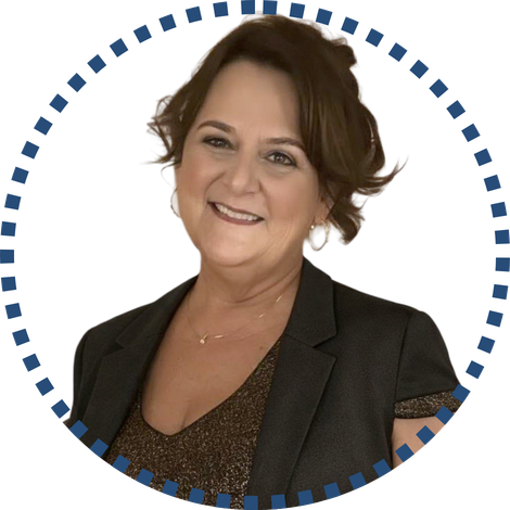 Smiling woman in professional attire with short hair, framed by a blue-patterned circle. Context: rural health professional.