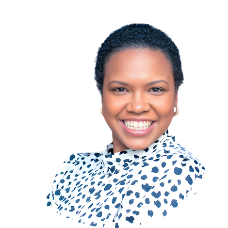 Smiling person in a black and white polka dot blouse, representing rural health advocacy.