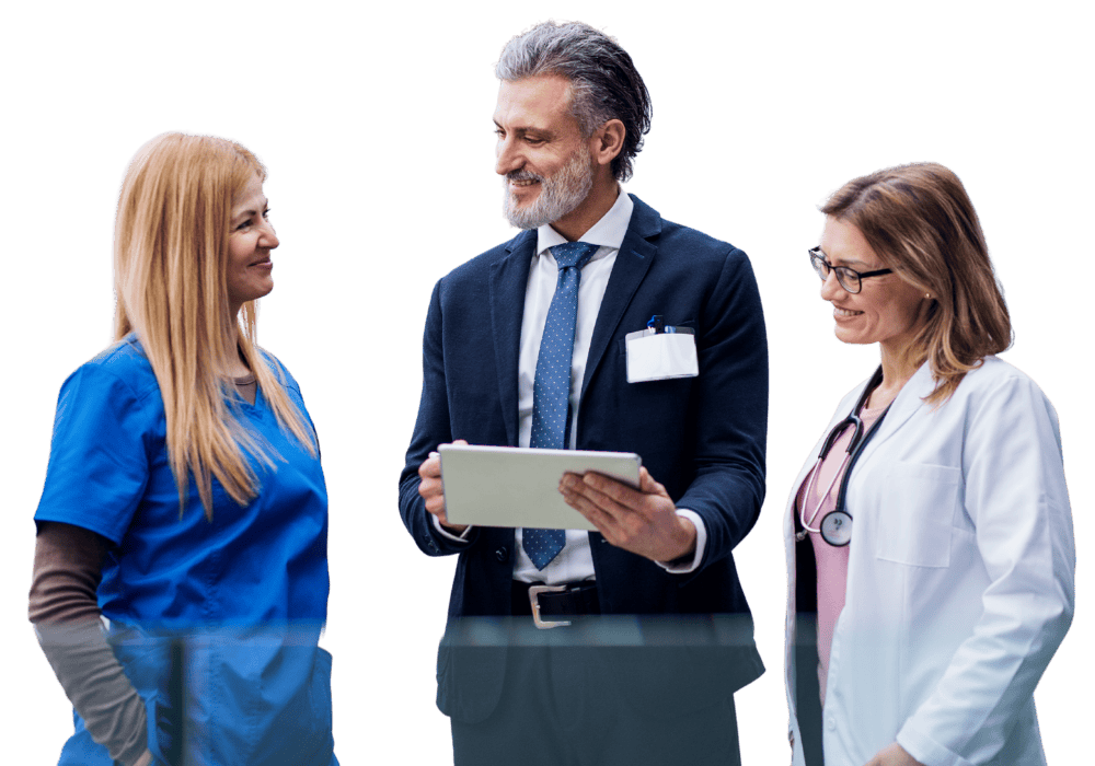 Healthcare professionals discussing rural health strategies, smiling, with one holding a tablet.